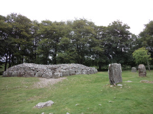 Clava Cairn. It would have had a stone vaulted ceiling, with the entrance passage only tall enough to crawl through. Earth covering the whole thing.
